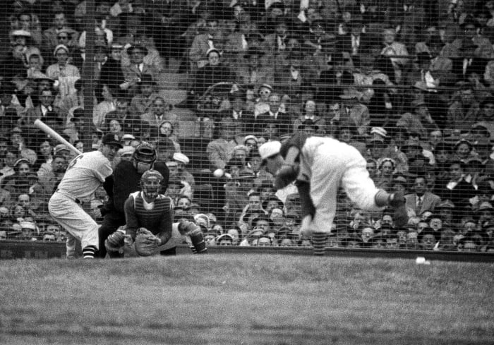 St. Louis's Stan Musial takes his licks against Cincinnati's Johnny Klippstein at Crosley Field on Opening Day in 1957.